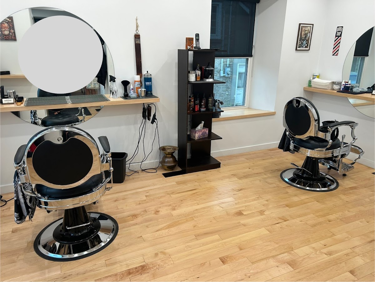 Inside Stone Street Barbershop — two vintage barber chairs and classic decor