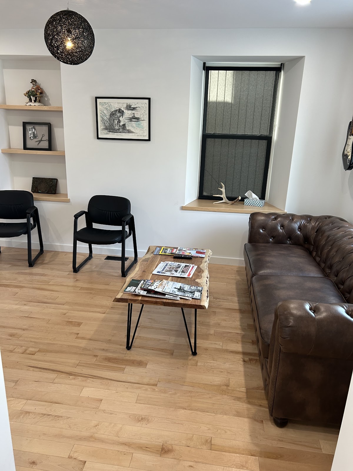 Stone Street Barbershop waiting area with Chesterfield sofa